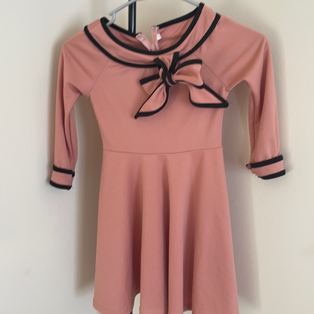 Peach cocktail dress with black trim size 5yrs.